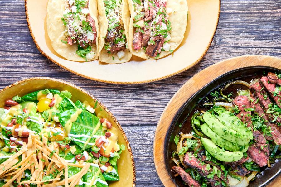 The Restaurants at Rosen Shingle Creek: A Different Dinner Every Night 9 An overhead shot of three plates, one with a salad, one with fajitas, and one with tacos from Mi Casa at Rosen Shingle Creek.