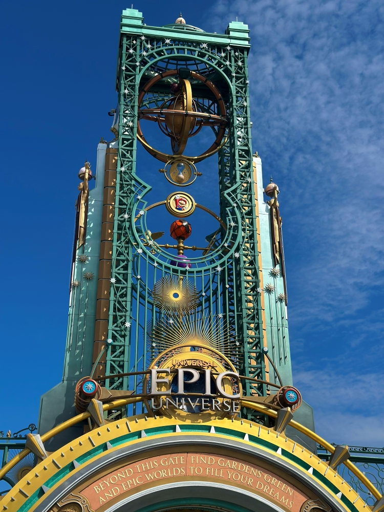 The celestial-inspired portal with a tall green spire at Epic Universe. 