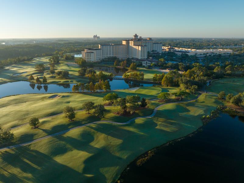 An aerial shot of Rosen Shingle Creek and the surrounding golf course at sunrise, close to Orlando's top theme parks.