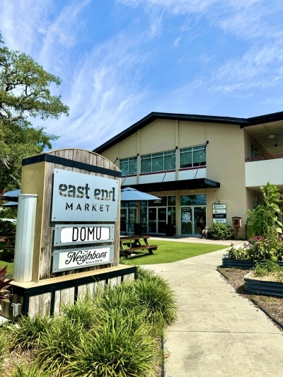 Eats for Everyone: 6 Must-Try Food Halls in Orlando 3 A two-story building with a sign out front that reads East End Market, Domu, and Provisions.
