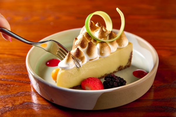 Magical Dining 2026 at A Land Remembered in Orlando 4 A fork cuts into a slice of key lime pie with toasted meringue during Magical Dining 2026.
