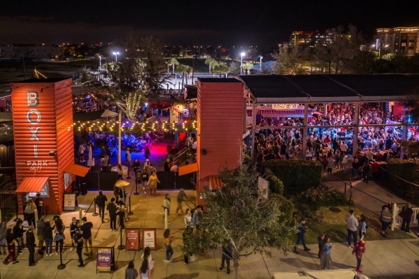 Eats for Everyone: 6 Must-Try Food Halls in Orlando 4 A large outdoor food hall from a distance at night with string lighting and large crowds. Boxi Park is one of the best food halls in Orlando.