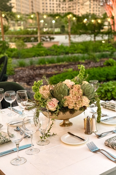 Emma's Creekside Farm: True Farm to Table at Rosen Shingle Creek 7 An elegant centerpiece with fresh artichokes and pink roses sits on a table during an event held in Emma's Creekside Farm.