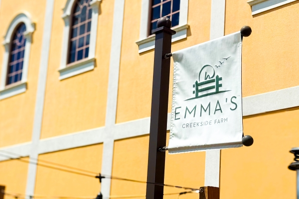 Emma's Creekside Farm: True Farm to Table at Rosen Shingle Creek 2 A sign for Emma's Creekside Farm hanging outside the rich yellow exterior of Rosen Shingle Creek.