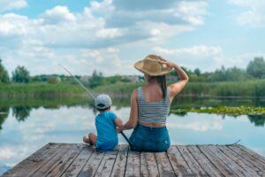 A mother and child go fishing on a pier. Orlando has many such fishing spots.