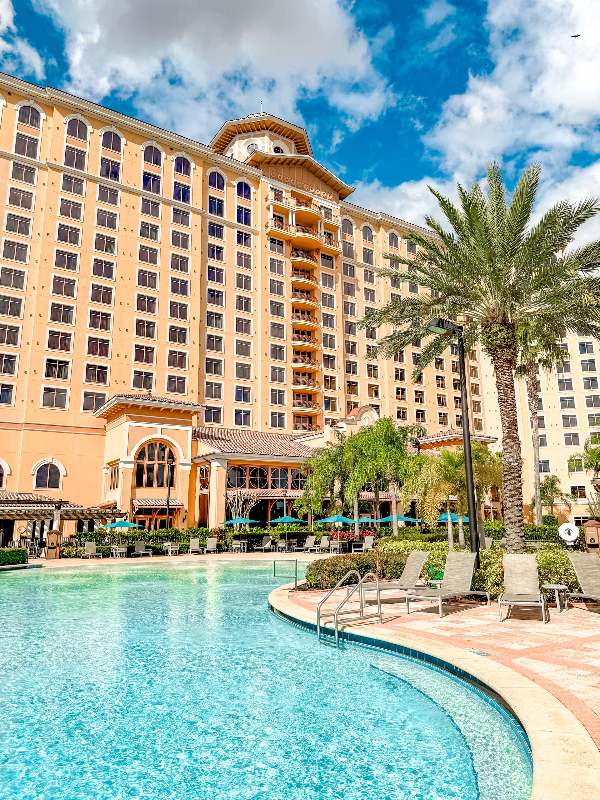 The Restaurants at Rosen Shingle Creek: A Different Dinner Every Night 20 The back of Rosen Shingle Creek, towering tall over a swimming pool and palm trees.