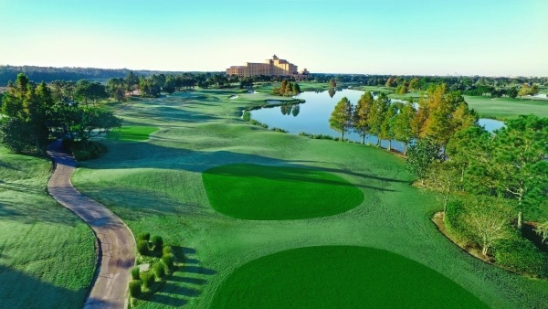 A sprawling golf course with a lake, trees, and Rosen Shingle Creek in the background.