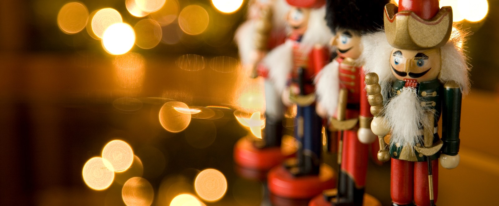 A row of four nutcrackers with circles of light in the background