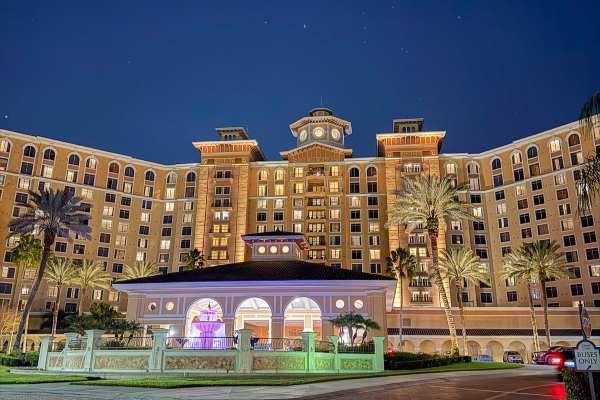 Halloween Horror Nights Returns for its 35th Year of Fear 5 The exterior of Rosen Shingle Creek at night, with glowing windows against a dark blue sky.