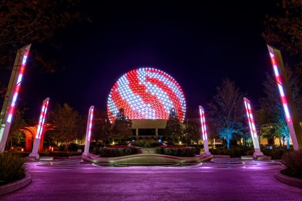 The Ultimate Guide to Orlando Holiday Events 4 EPCOT's Spaceship Earth and surrounding light fixtures with red and white lights like peppermints during the holiday events.