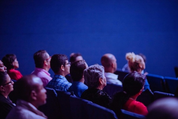 Have a Reel Good Time at the 2025 Florida Film Festival 4 A group of people in rows of seats all facing one direction in a dimly lit room.