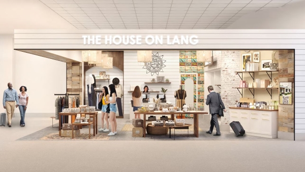 A storefront with white shiplap, modern shelving, and guests mingling around the small store.