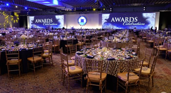 An event space with large screens that say 