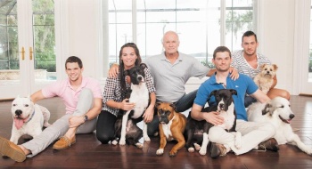 Rosen Shingle Creek Dog Policy welcomes dogs: Harris Rosen and his children sit in front of a bright window with six dogs