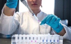 A scientist holding a needle.