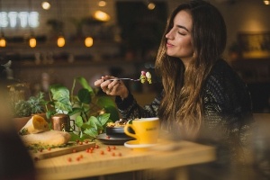 A woman eating mindfully on Global Unplug day. 